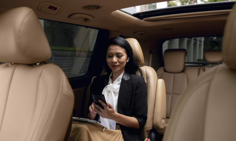 businesswoman-sitting-backseat-taxi