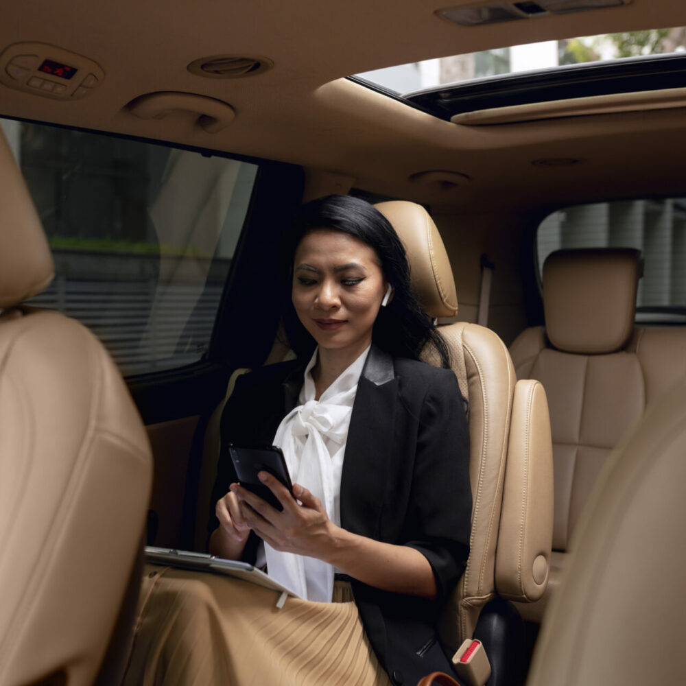 businesswoman-sitting-backseat-taxi businesswoman-sitting-backseat-taxi